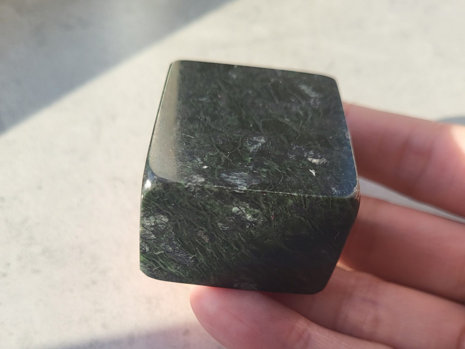 Showing the crisp edge and smooth corners of the Nephrite Jade cube