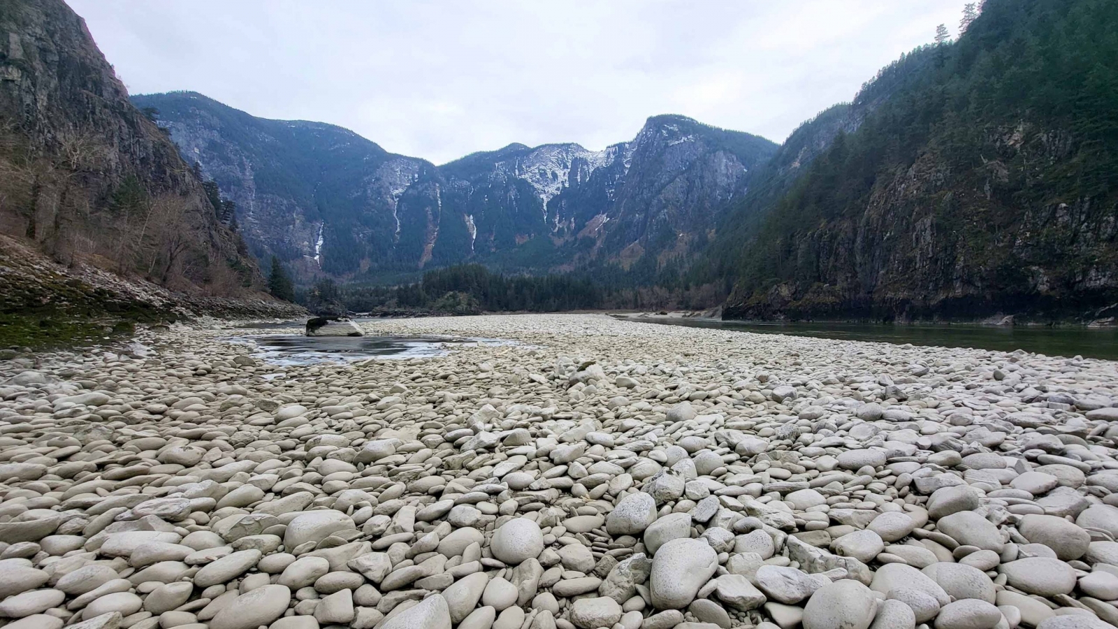 Large rock bed with mountainous background.