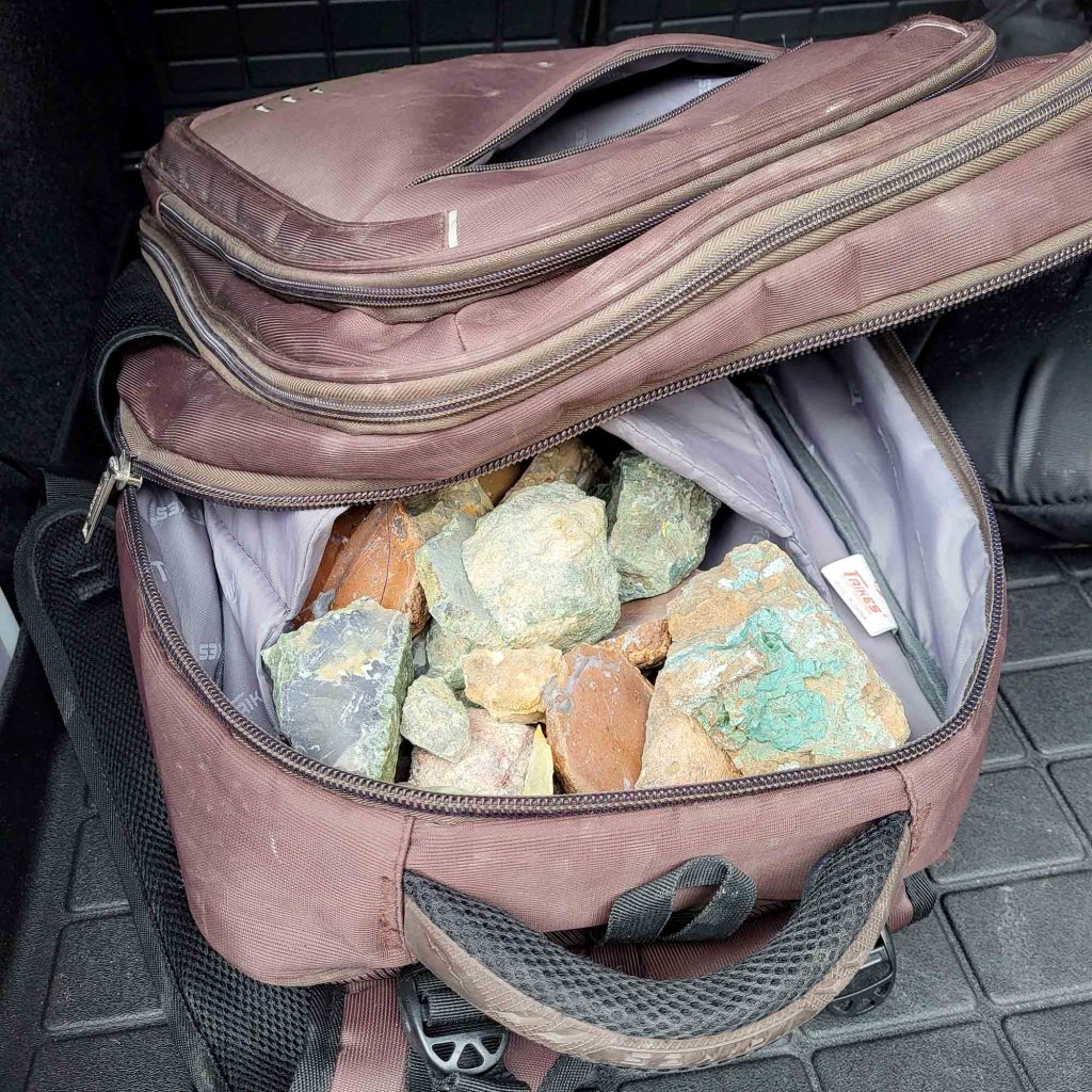 A backpack full of rocks in an assortment of colours